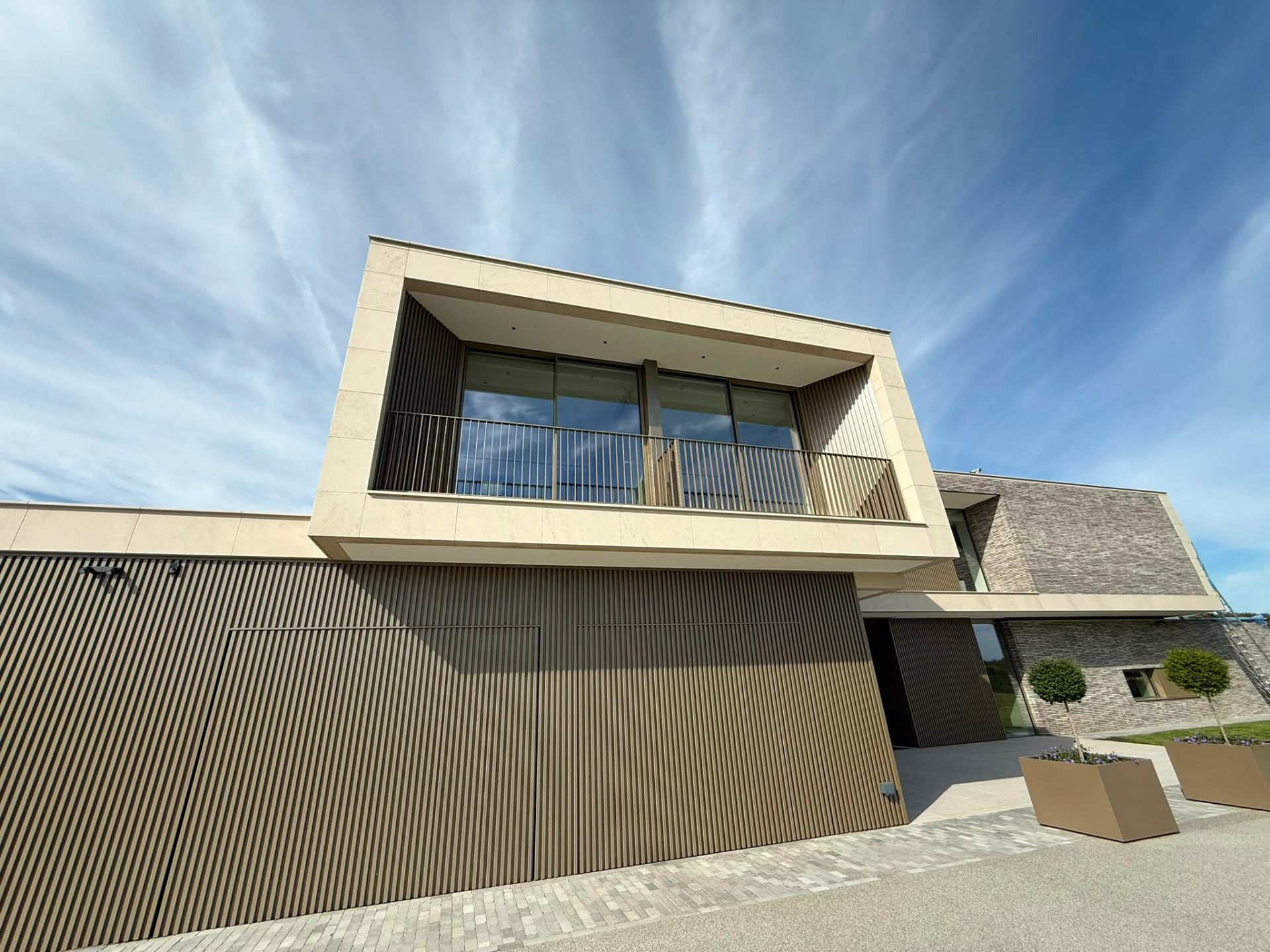 Sprayed bronze metal cladding on a modern home