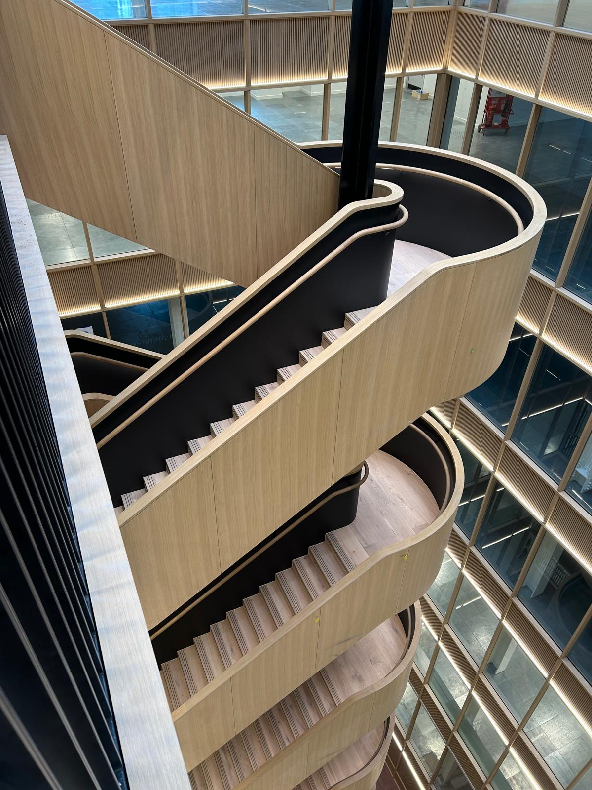 Sprayed oak-effect feature staircase in an atrium