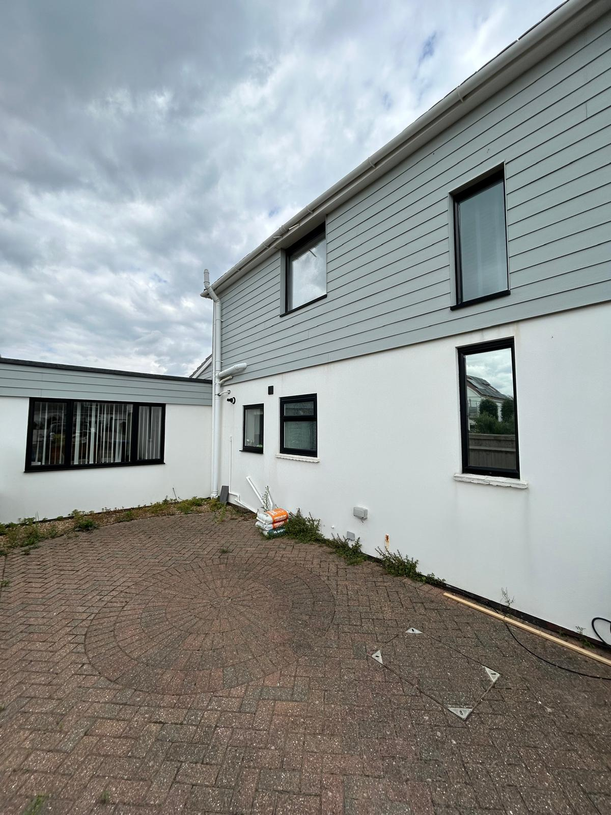 Refurbished sprayed exterior cladding